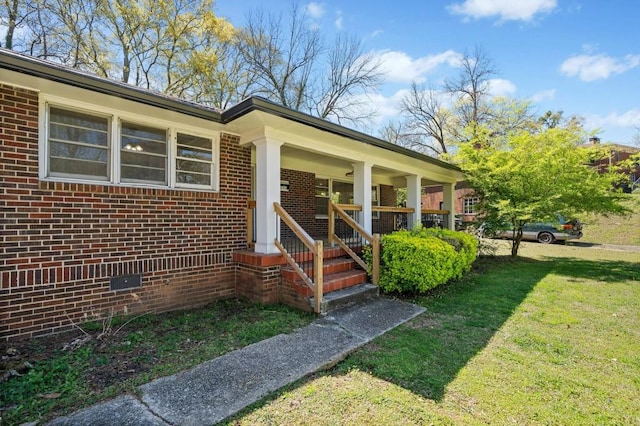 1286 Calhoun Ter SW, Atlanta, GA 30314 - entrance to property featuring covered porch, brick siding, and a lawn