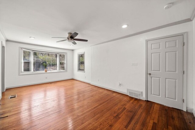 1286 Calhoun Ter SW, Atlanta, GA 30314 - spare room with visible vents, wood finished floors, ornamental molding, and a ceiling fan