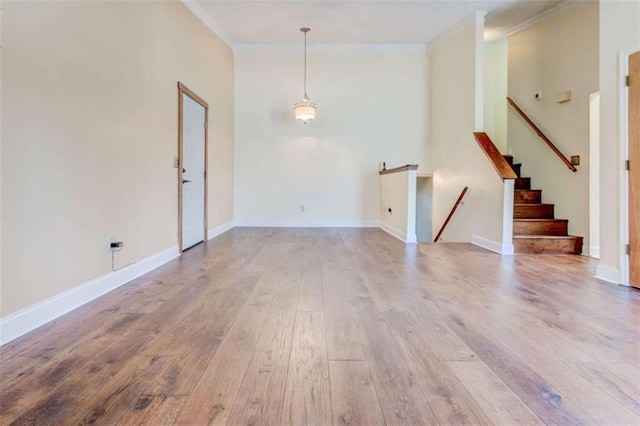 2211 Jonathan Ave, Lithonia, GA 30058 - unfurnished living room with ornamental molding, hardwood / wood-style flooring, stairway, and baseboards