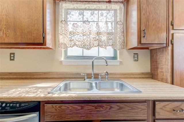 2211 Jonathan Ave, Lithonia, GA 30058 - kitchen with a sink, light countertops, dishwasher, and brown cabinetry