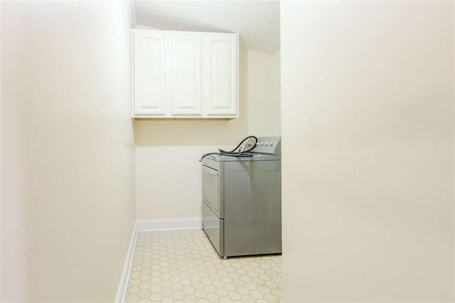 2211 Jonathan Ave, Lithonia, GA 30058 - laundry room with washer / clothes dryer, baseboards, cabinet space, and a textured ceiling