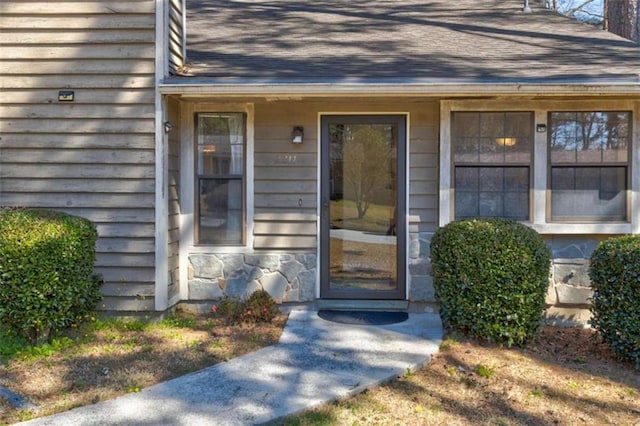2211 Jonathan Ave, Lithonia, GA 30058 - view of exterior entry with a shingled roof and stone siding