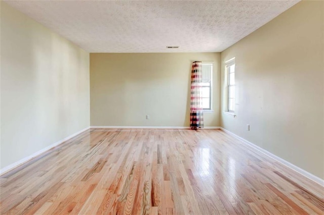 2211 Jonathan Ave, Lithonia, GA 30058 - spare room featuring light wood finished floors, a textured ceiling, and baseboards