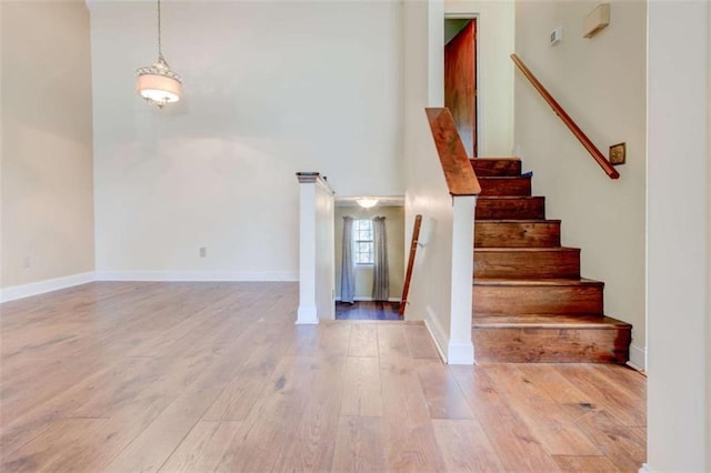 2211 Jonathan Ave, Lithonia, GA 30058 - stairs with wood-type flooring, a high ceiling, and baseboards