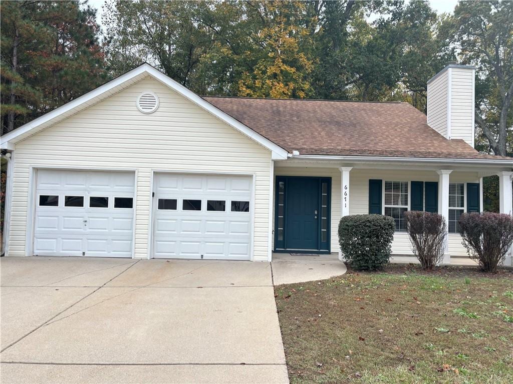 single story home featuring a porch and a garage