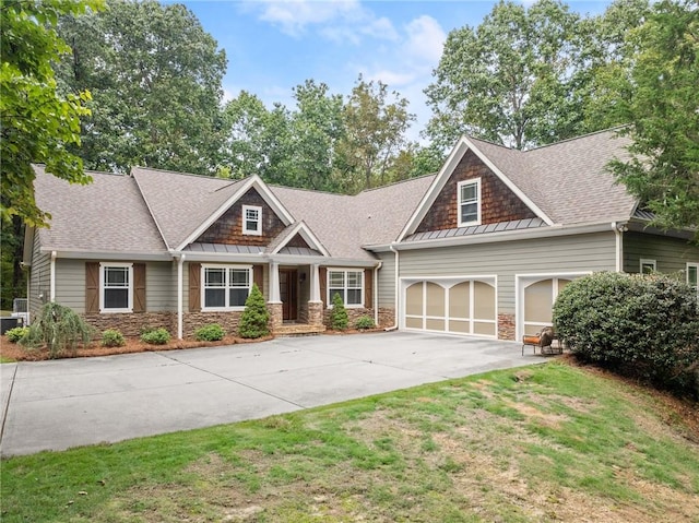 craftsman-style home with a front yard and a garage