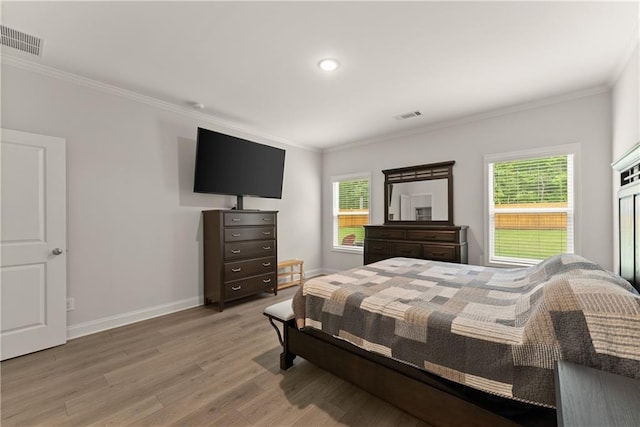 bedroom with light wood-style flooring, multiple windows, crown molding, baseboards, and recessed lighting