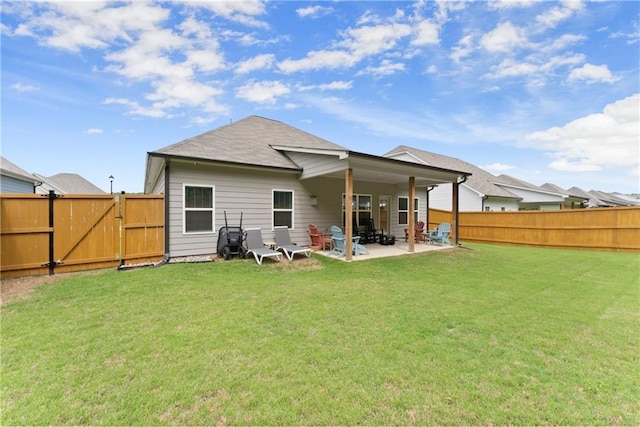 rear view of house with a patio and a gate