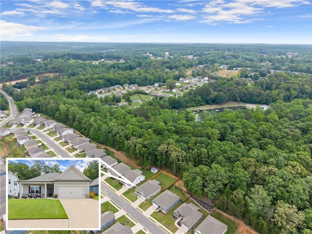 aerial perspective of suburban area featuring a forest