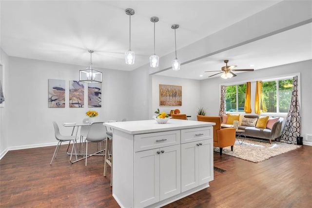 1893 Burning Tree Dr, Decatur, GA 30032 - kitchen with decorative light fixtures, a kitchen island, dark wood-style floors, and light countertops