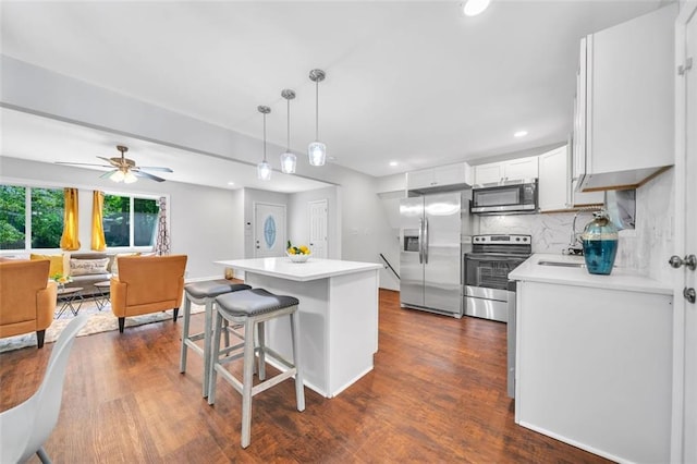 1893 Burning Tree Dr, Decatur, GA 30032 - kitchen with a kitchen bar, appliances with stainless steel finishes, dark wood-style floors, and light countertops