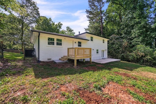 1893 Burning Tree Dr, Decatur, GA 30032 - back of house featuring crawl space, brick siding, a deck, and a lawn