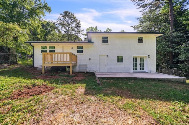 1893 Burning Tree Dr, Decatur, GA 30032 - back of house featuring a yard, french doors, a deck, a patio area, and brick siding