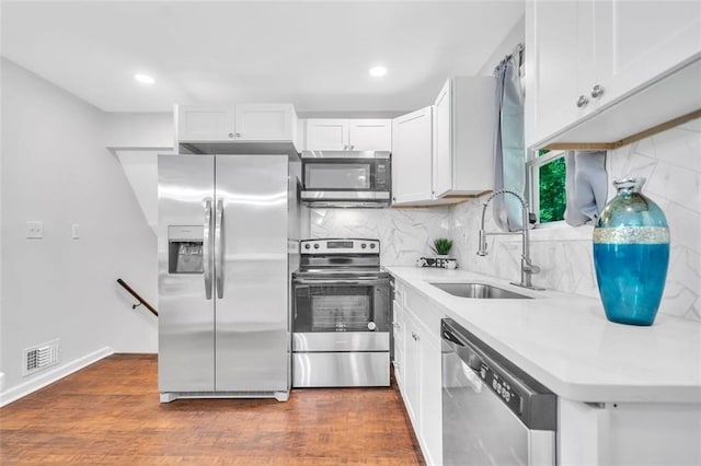 1893 Burning Tree Dr, Decatur, GA 30032 - kitchen with a sink, dark wood finished floors, backsplash, and stainless steel appliances
