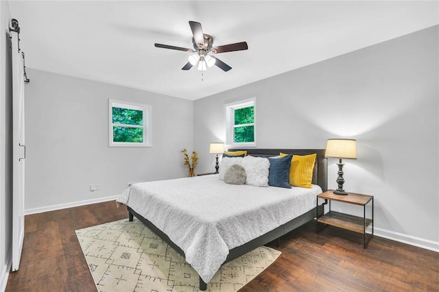 1893 Burning Tree Dr, Decatur, GA 30032 - bedroom featuring a barn door, baseboards, wood finished floors, and a ceiling fan