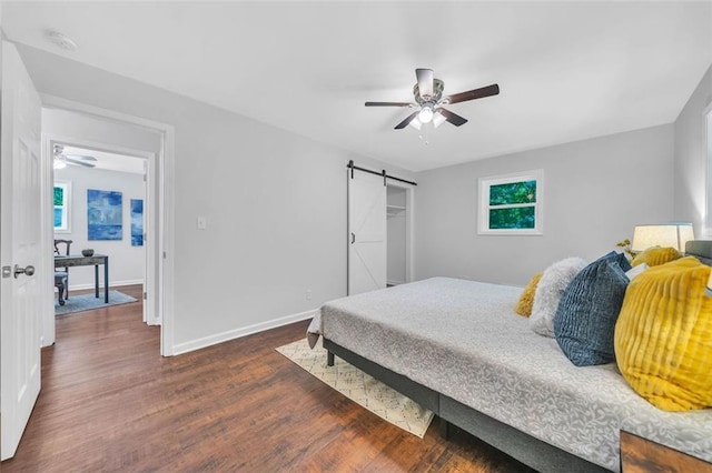 1893 Burning Tree Dr, Decatur, GA 30032 - bedroom with a barn door, baseboards, wood finished floors, and a ceiling fan