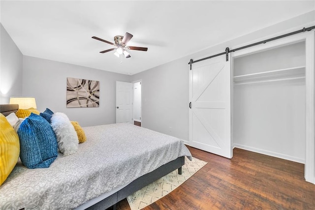 1893 Burning Tree Dr, Decatur, GA 30032 - bedroom with a barn door, baseboards, wood finished floors, and a ceiling fan