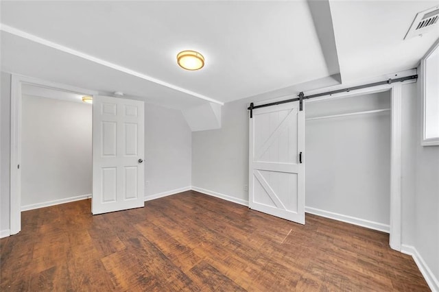 1893 Burning Tree Dr, Decatur, GA 30032 - interior space featuring a barn door, visible vents, baseboards, and wood finished floors