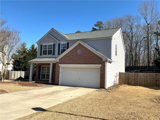 traditional home featuring concrete driveway, brick siding, fence, and an attached garage