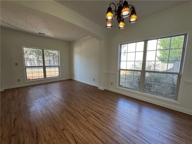 unfurnished room featuring visible vents, arched walkways, baseboards, dark wood-style flooring, and an inviting chandelier