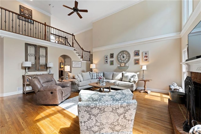 1254 Hadaway Garden Dr NW, Kennesaw, GA 30152 - living area with a high ceiling, arched walkways, ceiling fan, wood finished floors, and a brick fireplace