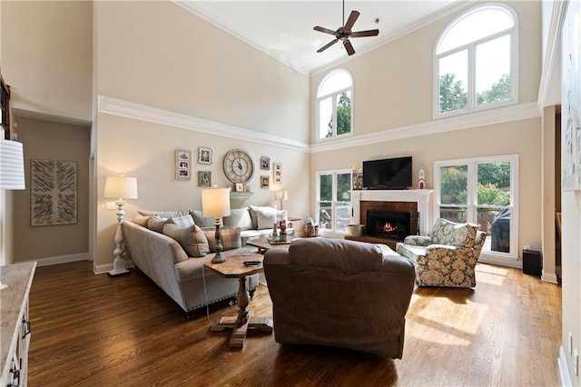 1254 Hadaway Garden Dr NW, Kennesaw, GA 30152 - living room with a ceiling fan, ornamental molding, a high ceiling, wood finished floors, and a brick fireplace