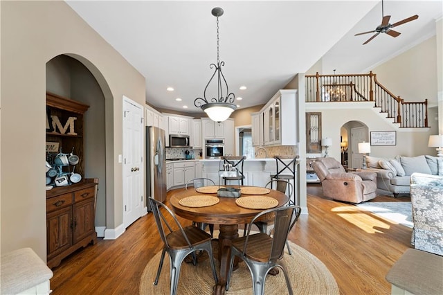 1254 Hadaway Garden Dr NW, Kennesaw, GA 30152 - dining room with arched walkways, a ceiling fan, light wood-style floors, recessed lighting, and crown molding