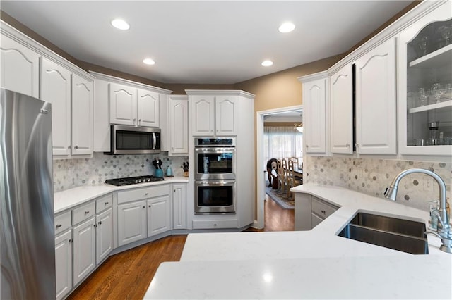 1254 Hadaway Garden Dr NW, Kennesaw, GA 30152 - kitchen featuring stainless steel appliances, glass insert cabinets, recessed lighting, white cabinets, and backsplash