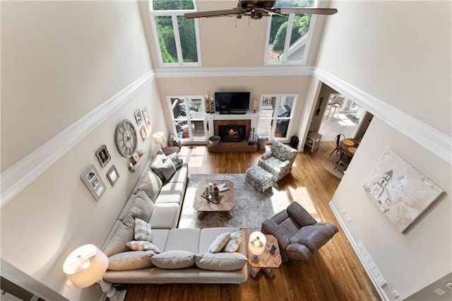 1254 Hadaway Garden Dr NW, Kennesaw, GA 30152 - living area with a towering ceiling, wood finished floors, a ceiling fan, and a brick fireplace