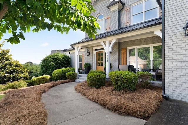 1254 Hadaway Garden Dr NW, Kennesaw, GA 30152 - entrance to property with a standing seam roof, brick siding, a porch, and a metal roof
