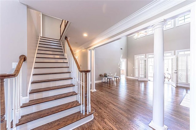 9175 Etching Overlook, Johns Creek, GA 30097 - staircase with ornate columns, ornamental molding, wood finished floors, baseboards, and recessed lighting