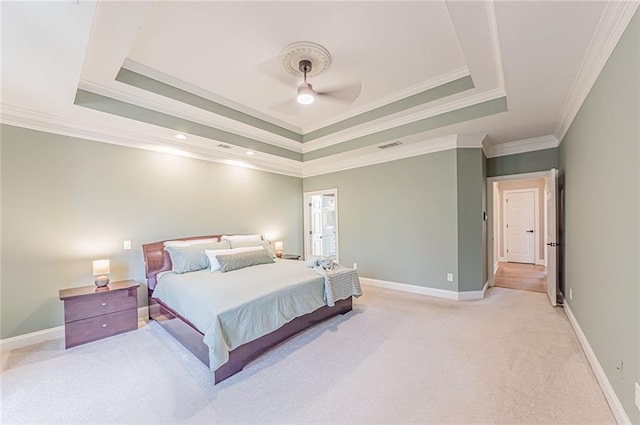 bedroom with visible vents, baseboards, a raised ceiling, light colored carpet, and ornamental molding