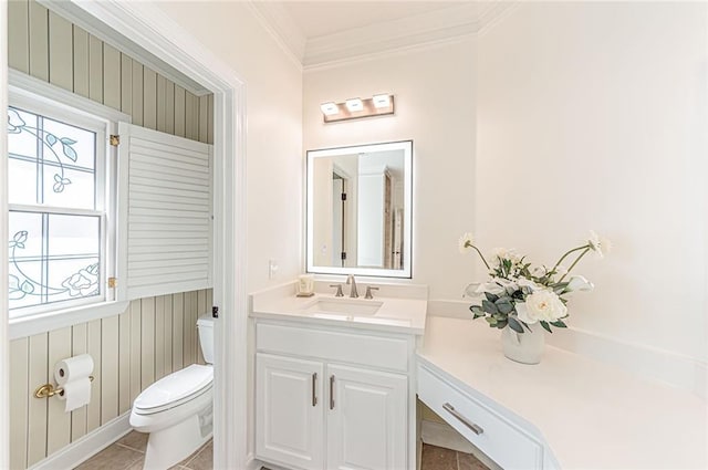 half bathroom featuring toilet, tile patterned flooring, vanity, and crown molding