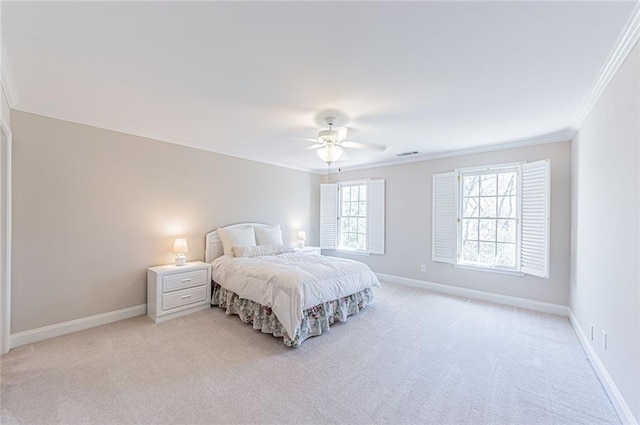 bedroom featuring ornamental molding, light carpet, and baseboards