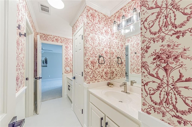 bathroom featuring crown molding, wallpapered walls, and visible vents