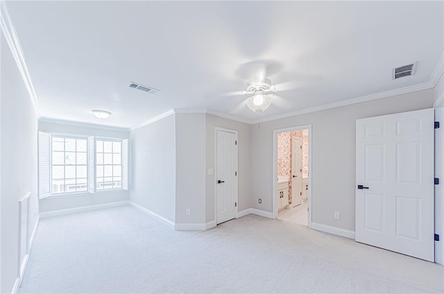 unfurnished bedroom with crown molding, light carpet, and visible vents