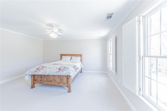 bedroom featuring baseboards, ornamental molding, visible vents, and carpet