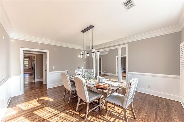 dining area with ornamental molding, visible vents, and wood finished floors