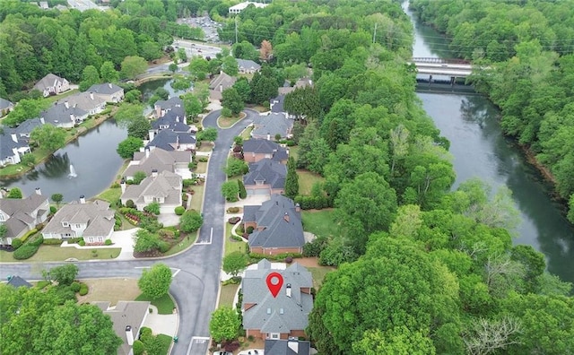 birds eye view of property with a water view and a residential view