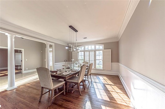 dining space featuring ornamental molding, ornate columns, visible vents, and wood finished floors