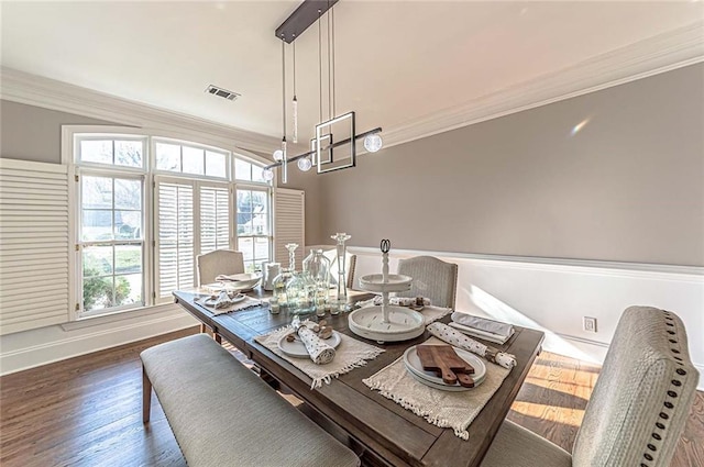 dining space with crown molding and a healthy amount of sunlight