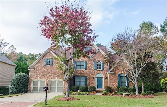 view of front of home featuring a front lawn and a garage