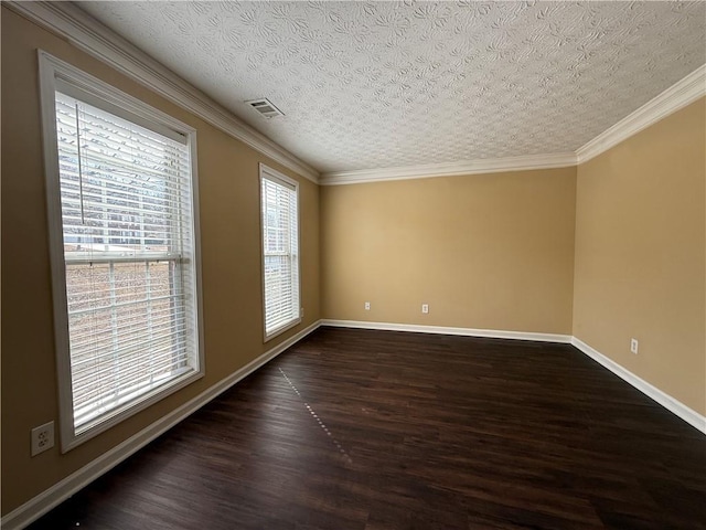 spare room with baseboards, visible vents, dark wood-style floors, a textured ceiling, and crown molding