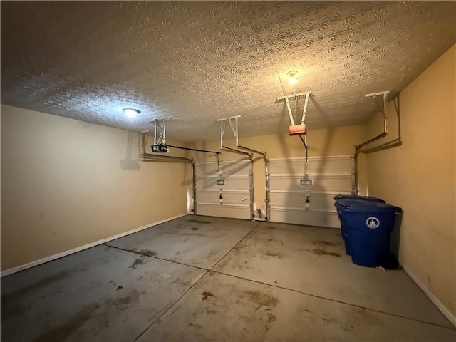 garage with baseboards and a garage door opener