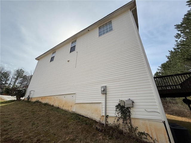 view of side of home featuring cooling unit