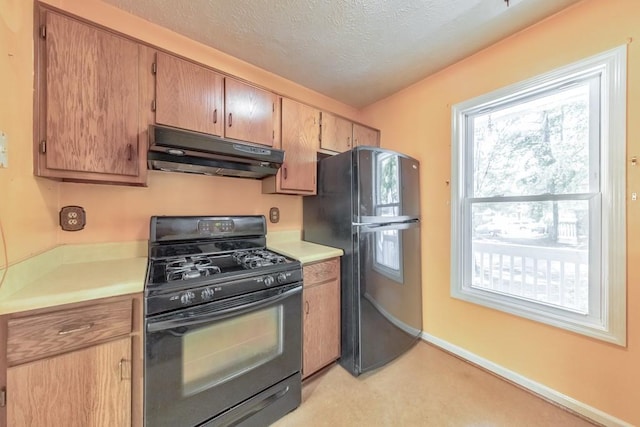350 Pleasant Oak Ct SW, Marietta, GA 30008 - kitchen featuring black appliances, under cabinet range hood, light countertops, a textured ceiling, and light colored carpet