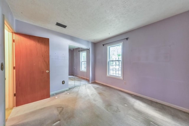 350 Pleasant Oak Ct SW, Marietta, GA 30008 - unfurnished bedroom with baseboards, a textured ceiling, carpet flooring, and a closet