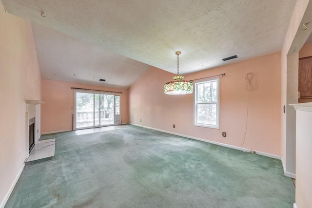 350 Pleasant Oak Ct SW, Marietta, GA 30008 - unfurnished living room with a textured ceiling, healthy amount of natural light, baseboards, a fireplace with raised hearth, and vaulted ceiling