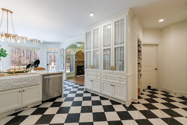 kitchen with recessed lighting, a fireplace, ornamental molding, stainless steel dishwasher, and tile patterned floors