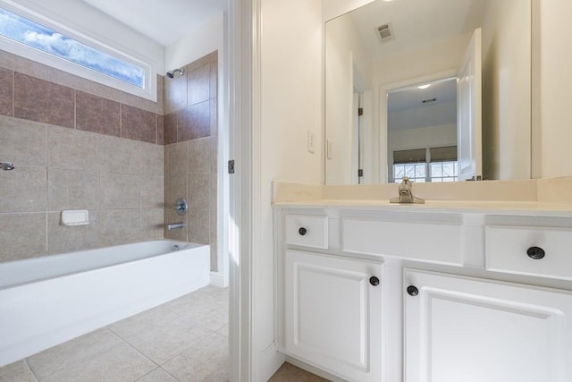 bathroom featuring vanity, tile patterned floors, visible vents, and shower / washtub combination